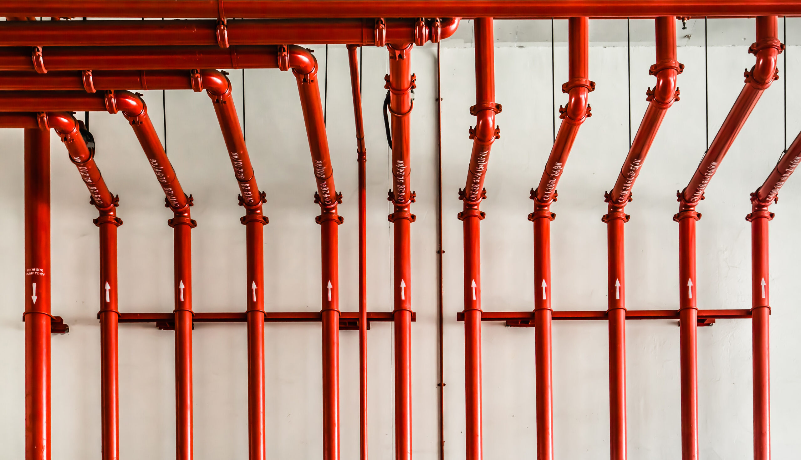 red color metal pipe on white wall